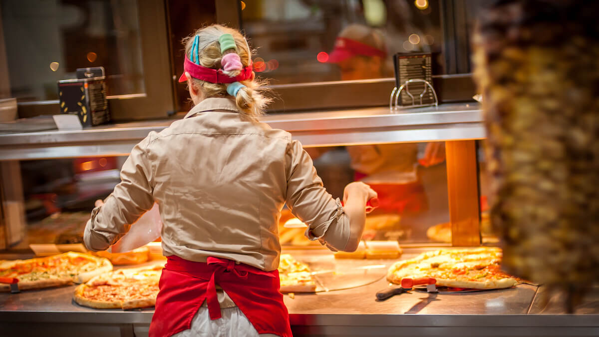 Woman selling pizza