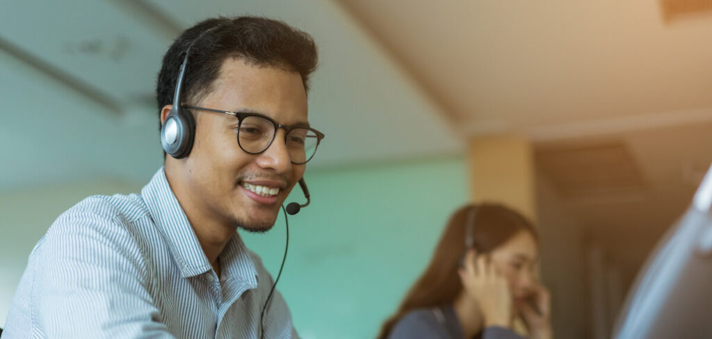 What is a call center? Man talks on headset in call center