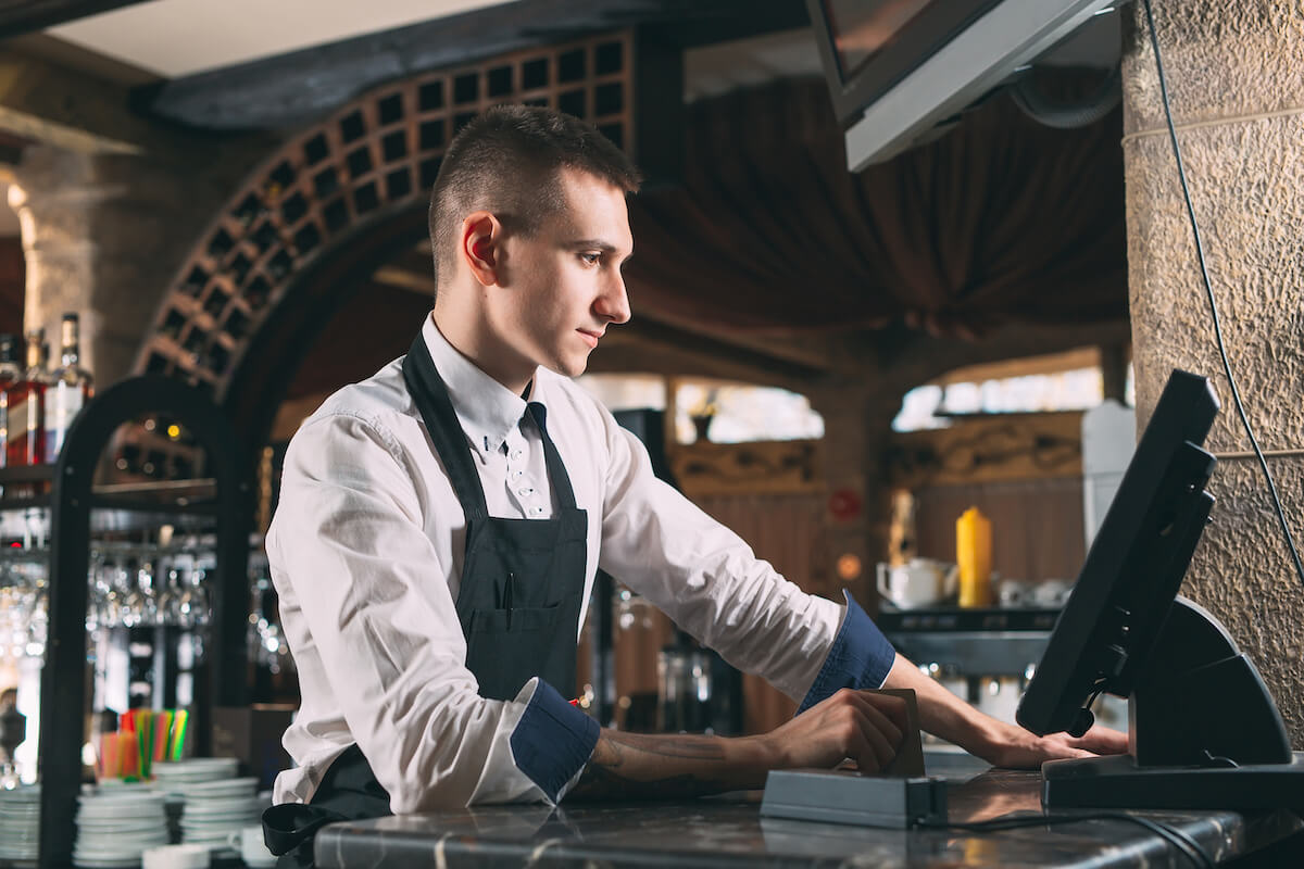 Restaurant ordering system: waiter using a POS machine