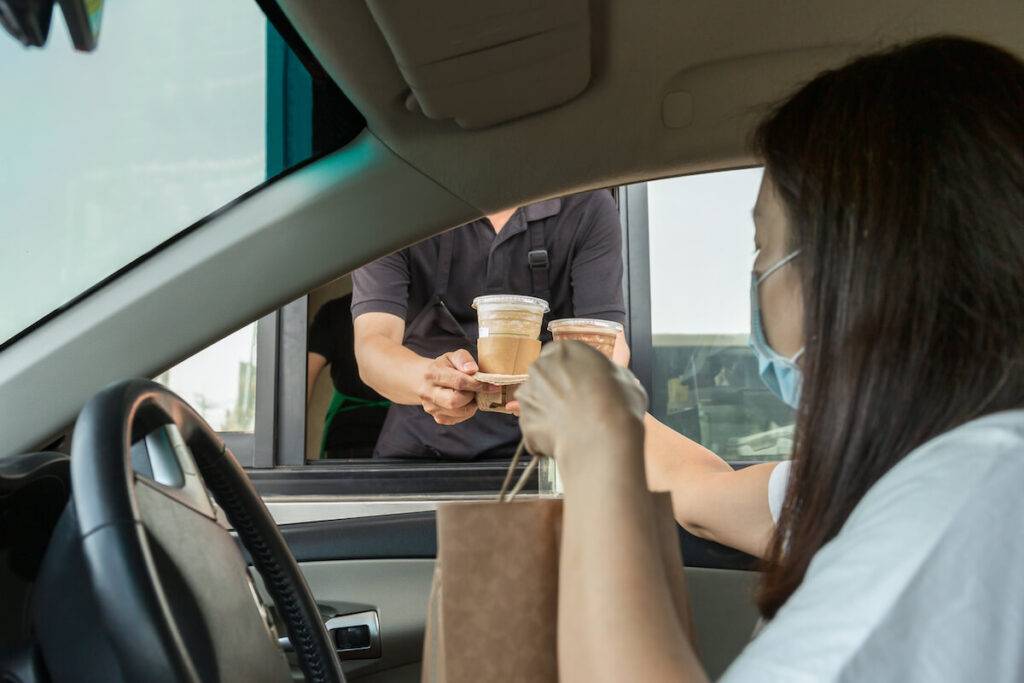 Restaurant drive thru: woman getting her orders from a drive thru restaurant