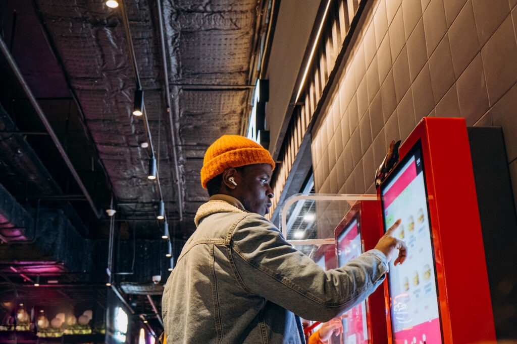 Person ordering from a digital kiosk